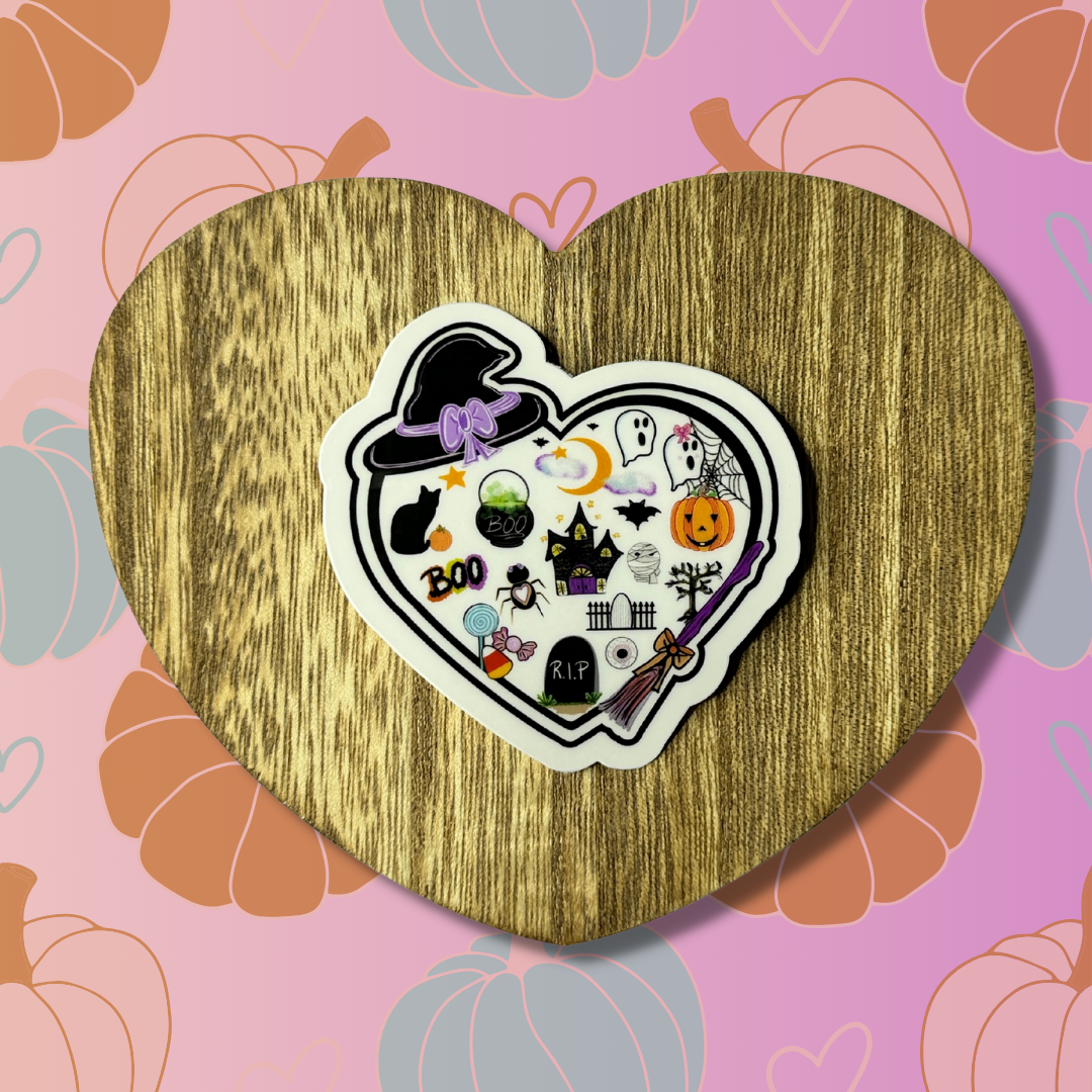 A black heart with ghosts, spiders, haunted houses, and more Halloween-related items.