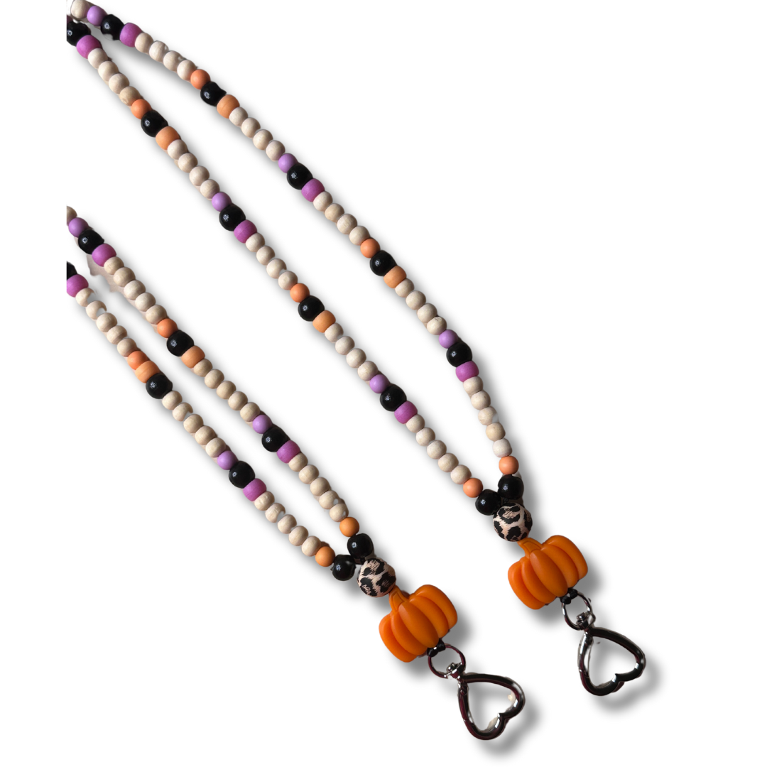 Handcrafted fall pumpkin lanyard with vibrant orange silicone pumpkin charm, wooden beads, and nylon cord on a white background
