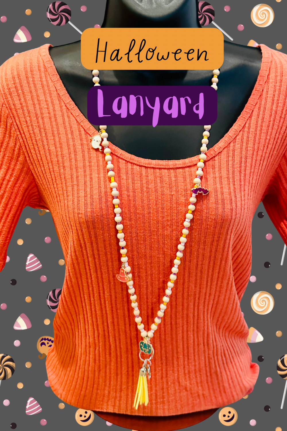 The Halloween Lanyard on a mannequin wearing an orange sweater. The background is grey with images of candy.