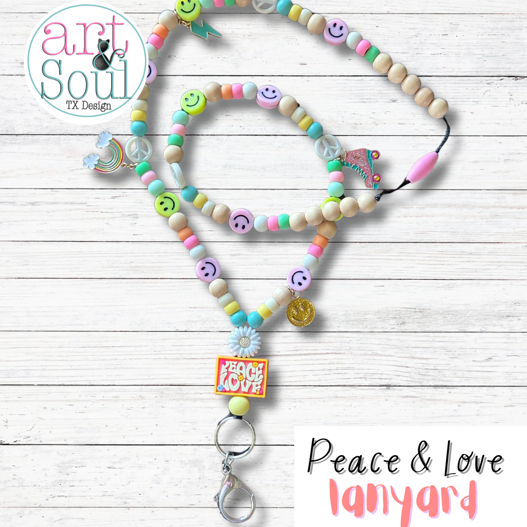A full view of the Peace and Love lanyard. All the roller skate and rainbow charms can be seen.