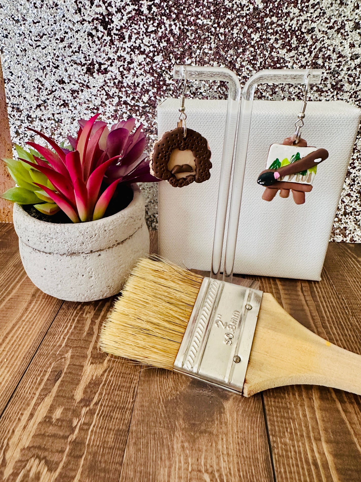 Detailed view of Bob Ross polymer clay earrings highlighting the vibrant paint palette colors and realistic portrait features.