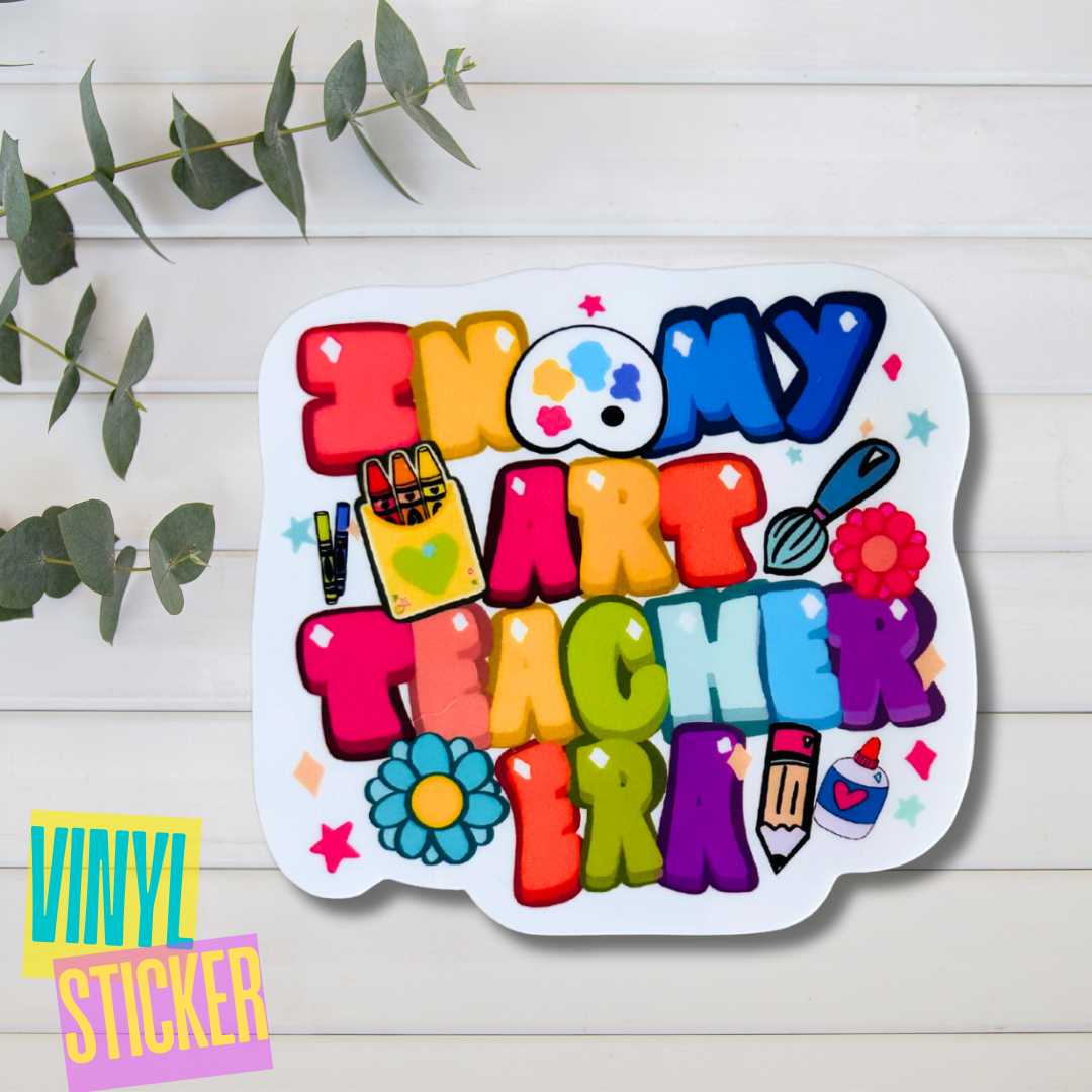 A colorful vinyl sticker with art-themed elements such as a paintbrush, pencils, and flowers, with the text 'In My Art Teacher Era'.