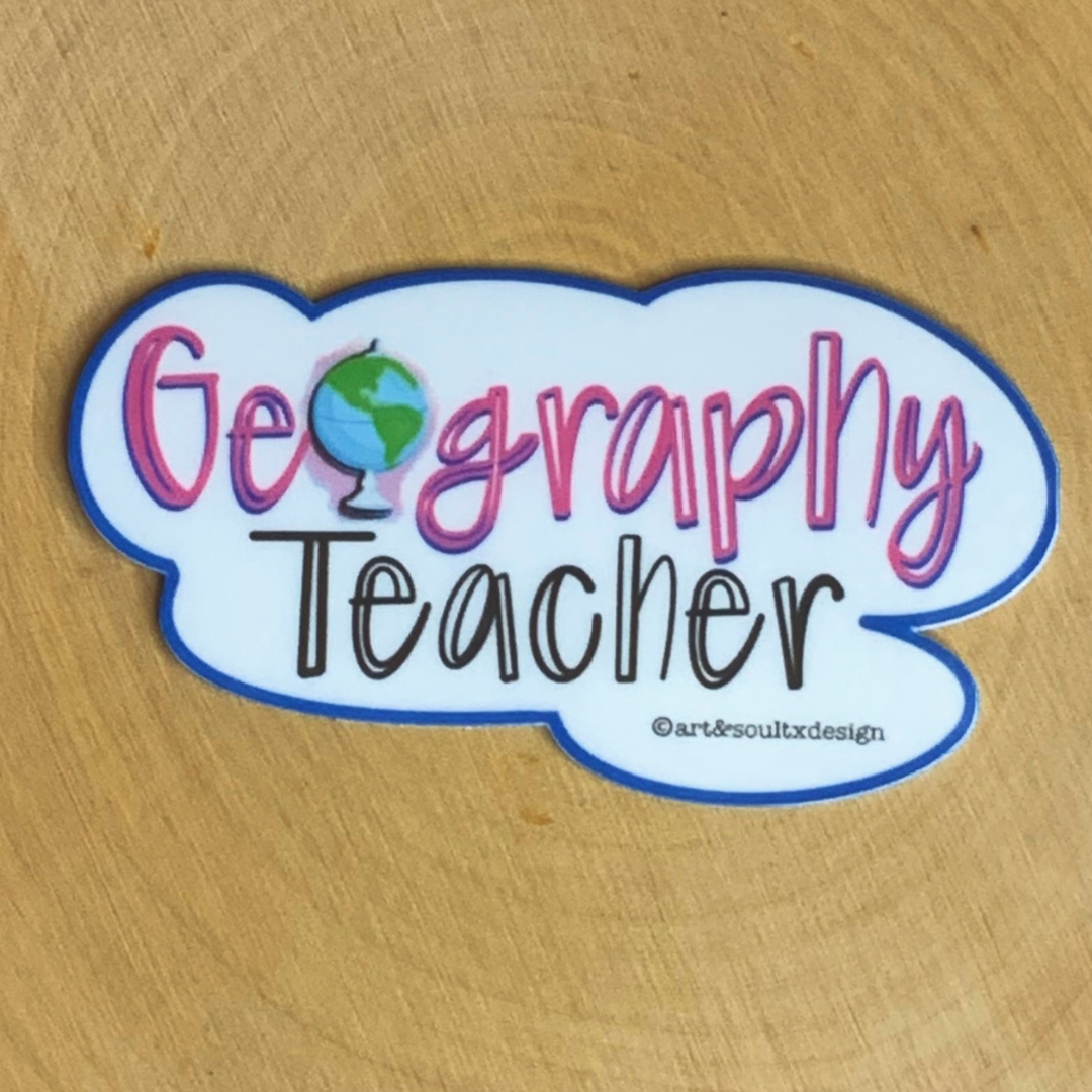 Geography Teacher sticker with globe design laying flat on light brown table showing pink text and globe detail.