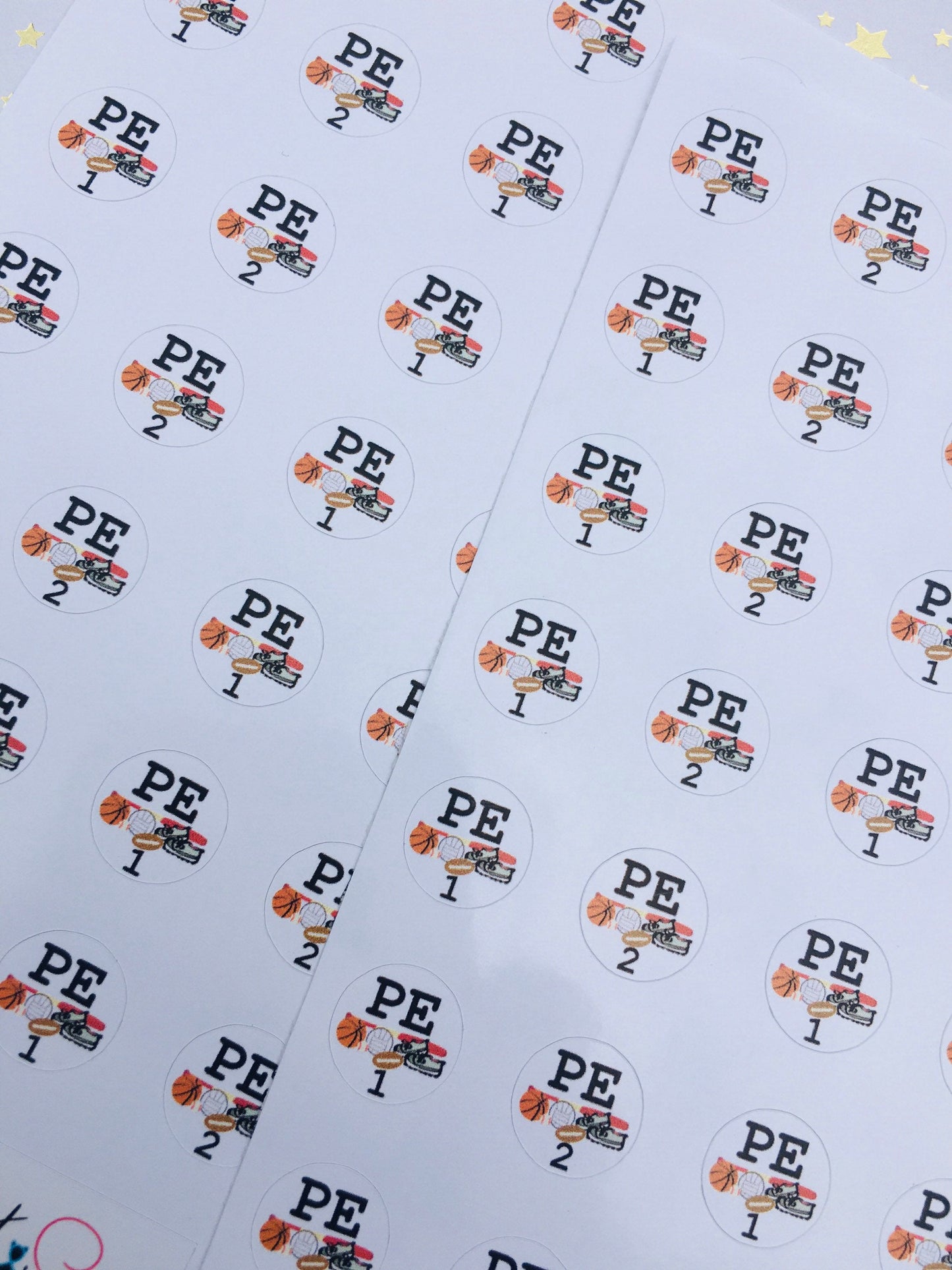 Close-up of P.E. rotation sticker sheets with baseball, basketball, and football sports designs