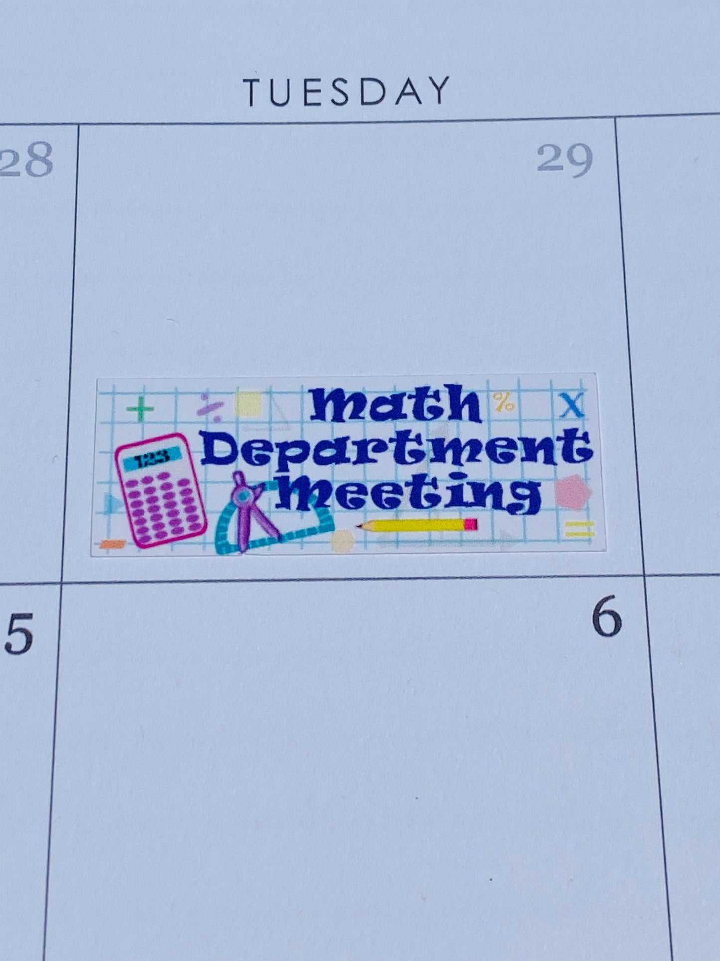 A close up of the Math Department Meeting sticker. It has drawings of graph paper, a calculator, a compass, a pencil, and various math symbols.