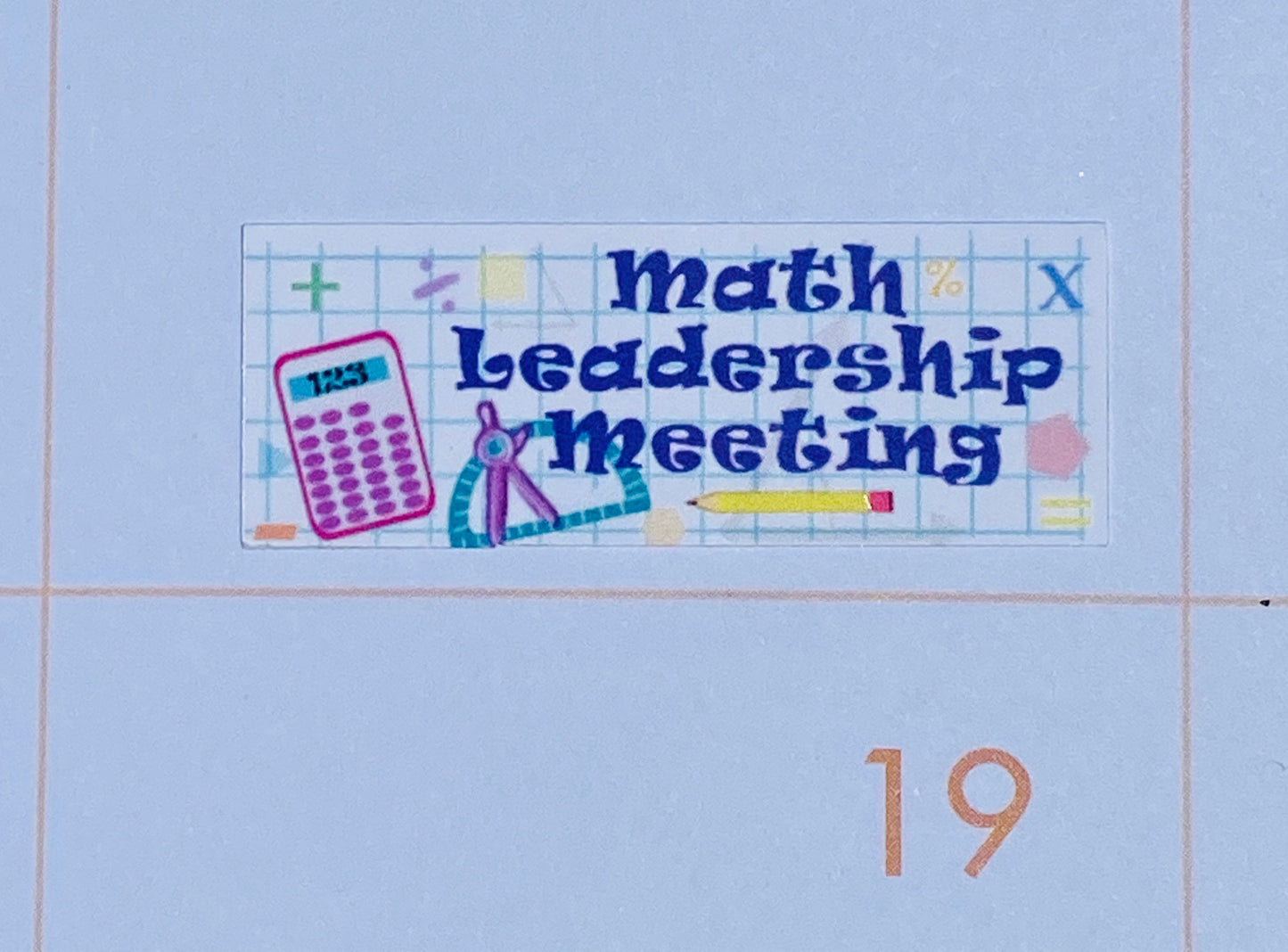 A close up of the Math Leadership Meeting sticker. It has drawings of graph paper, a calculator, a compass, a pencil, and various math symbols.