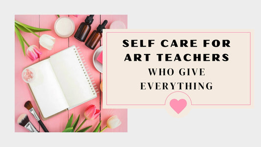 A journal, essential oils, tulips, and other self-care essentials on a pink table.