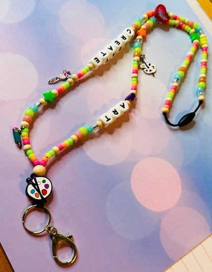 Close-up view of the breakaway safety clasp on the art teacher lanyard for secure badge and key holding