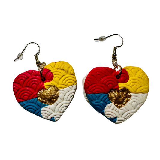 Colorful heart-shaped earrings with gold accents on a white background.