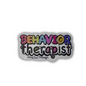 A sticker with the text 'Behavior herapist' in a colorful, playful font, predominantly white with multicolor letters, designed for use on various surfaces.
