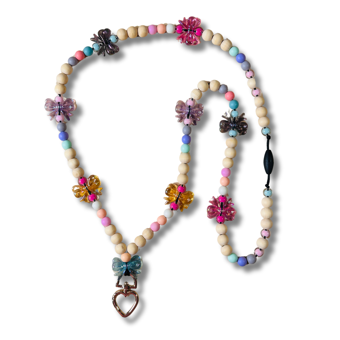 A full image of the Teacher Lanyard with colorful bows, wooden beads, and a golden heart-shaped key chain.