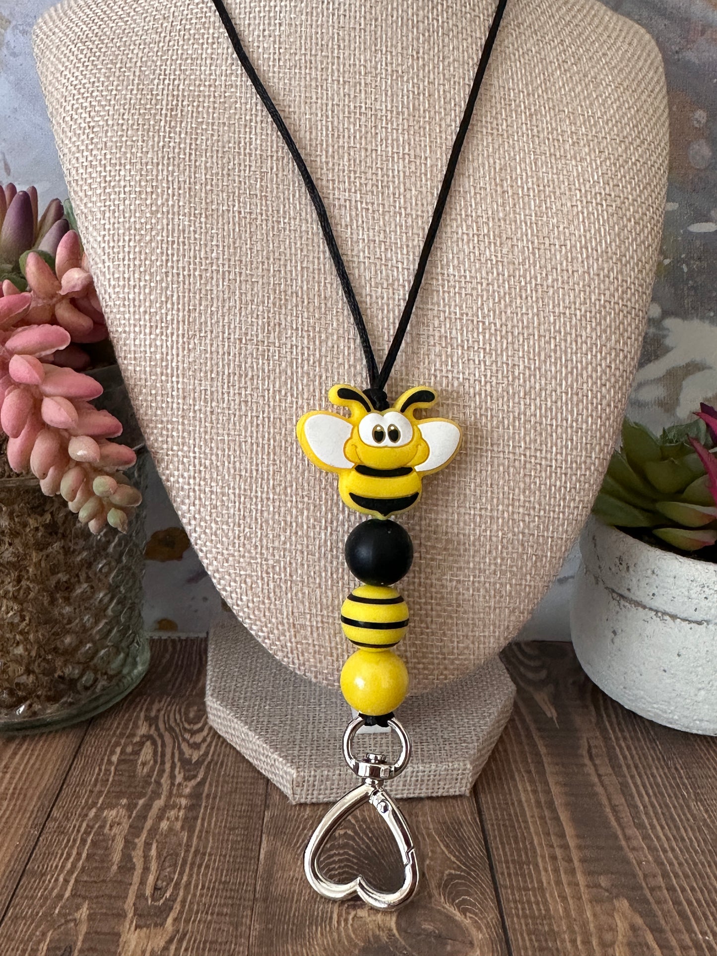 Bumble bee teacher lanyard shown on mannequin displaying comfortable length and handmade beaded design