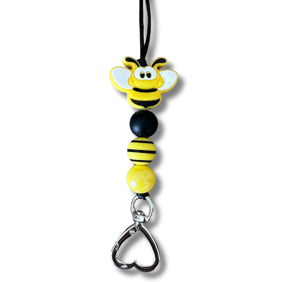 Bumble Bee Lanyard Charm Detail
Alt Text: Handmade bumble bee charm with heart-shaped metal clasp on teacher lanyard, Texas made beaded design close-up.
