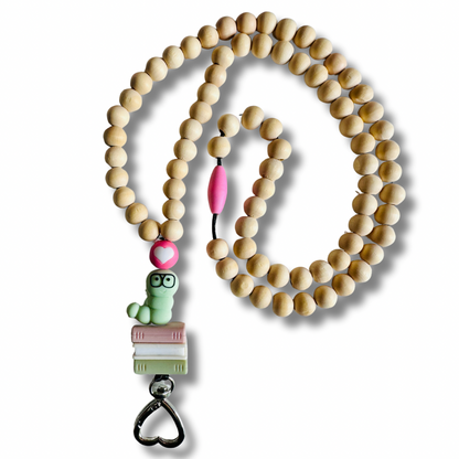 Wooden beaded lanyard with cute bookworm character holder on a white background.