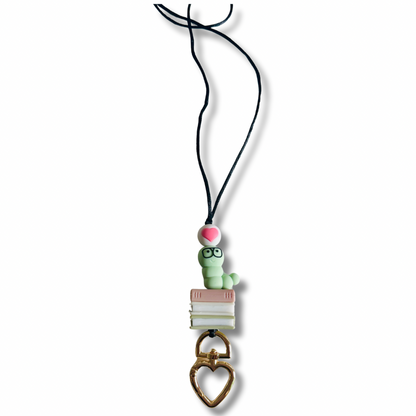 Nylon string necklace with a green character charm on a white background.