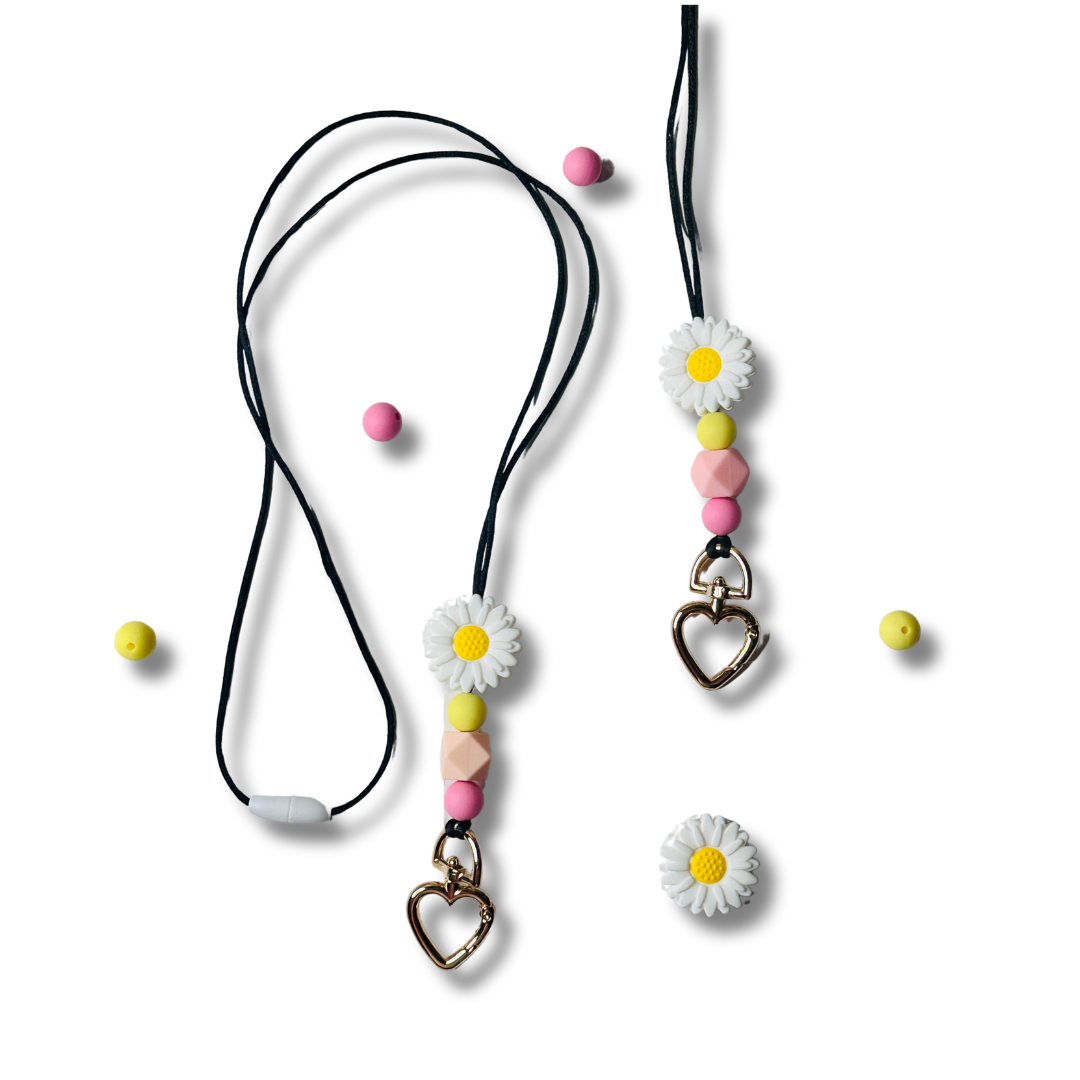 Handmade daisy flower lanyards with pink and yellow silicone beads on white background, beaded ID badge holder for teachers.