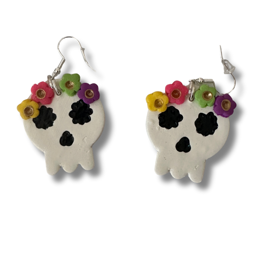 Handmade flowery skull polymer clay earrings on white background with colorful flower crown, Dia de los Muertos teacher jewelry