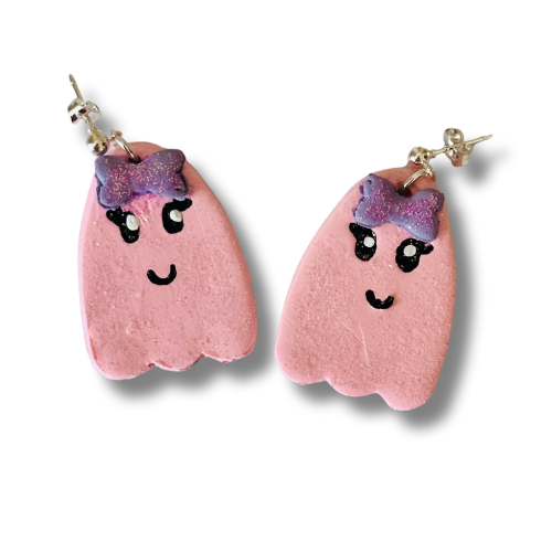 Handmade friendly pink ghost earrings on white background with cute bowties, hand-drawn smiles and eyes, polymer clay Halloween.