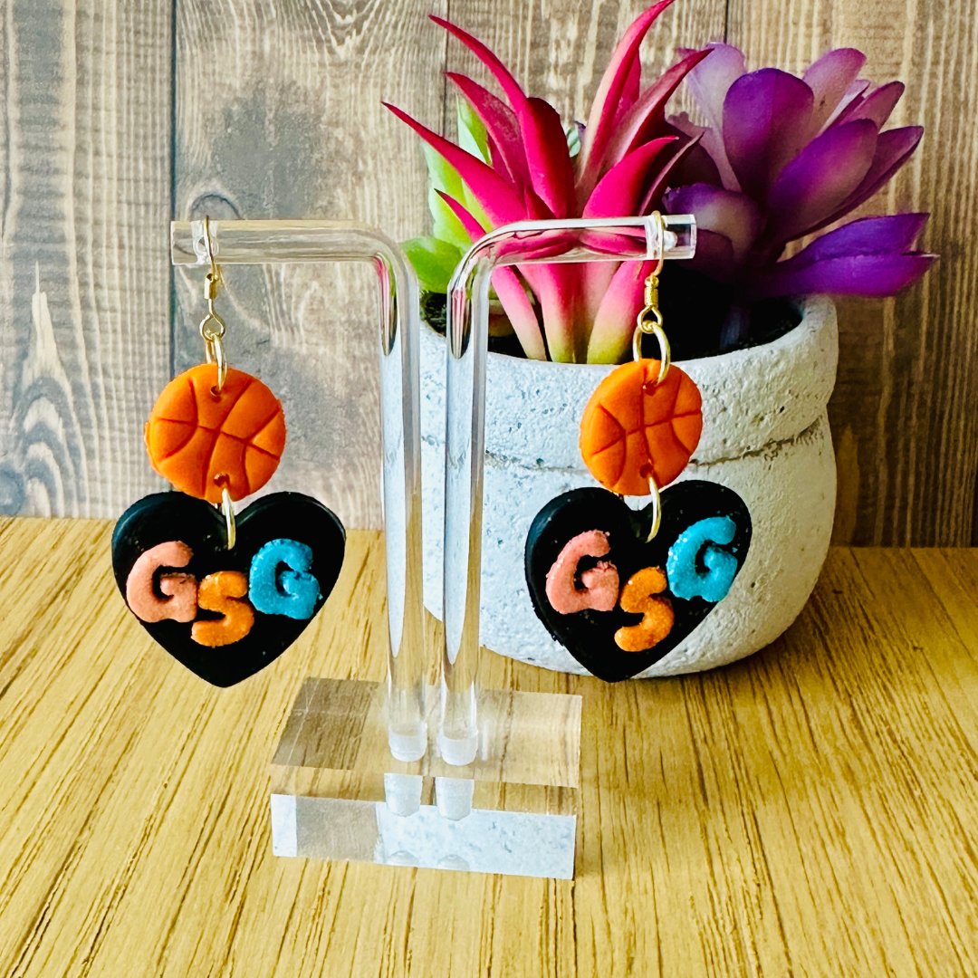 Handmade orange basketball and Spurs-colored GSG heart polymer clay earrings on earring stand, 24k gold hooks, Texas-made.