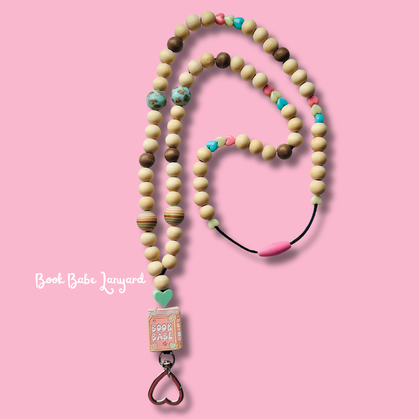 Wooden beaded lanyard with colorful heart-shaped beads on a pink background