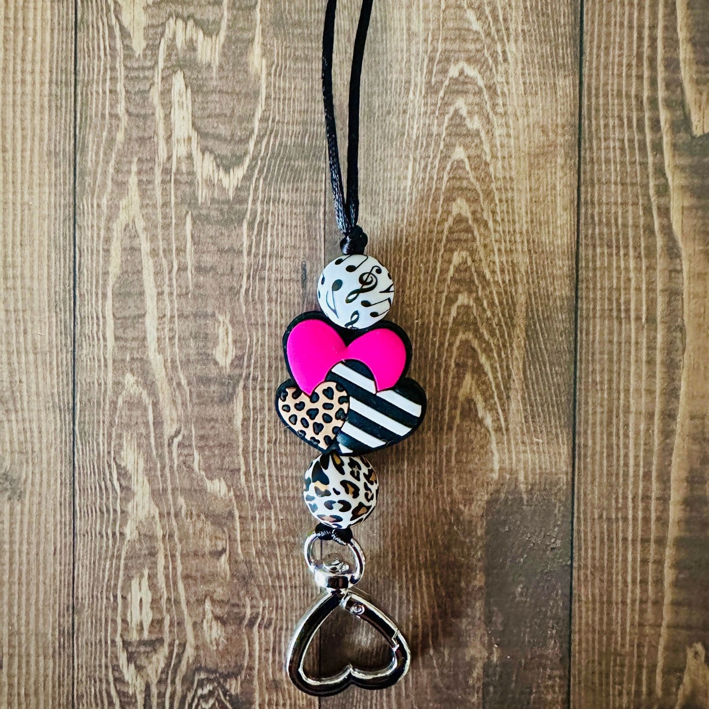 Close up of the Music Love lanyard on a wooden background surface. 