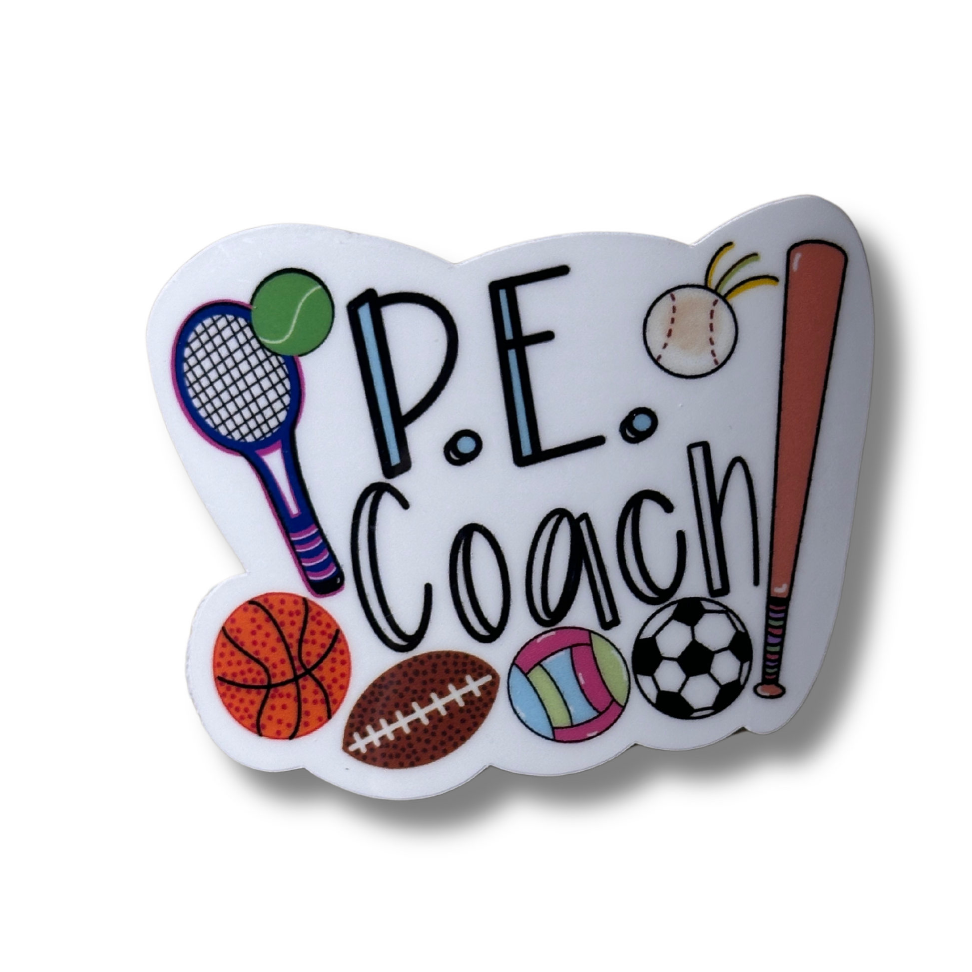 Close-up of P.E. Coach waterproof vinyl sticker on white background, showing bold text with basketball, football, baseball bat, tennis racket, soccer ball, and volleyball.