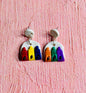 The Primary Color Earring is on the left, with red blue , and yellow crayons on a white background.  The Secondary Color Earring is on the right with orange green, and purple crayons on a white background.