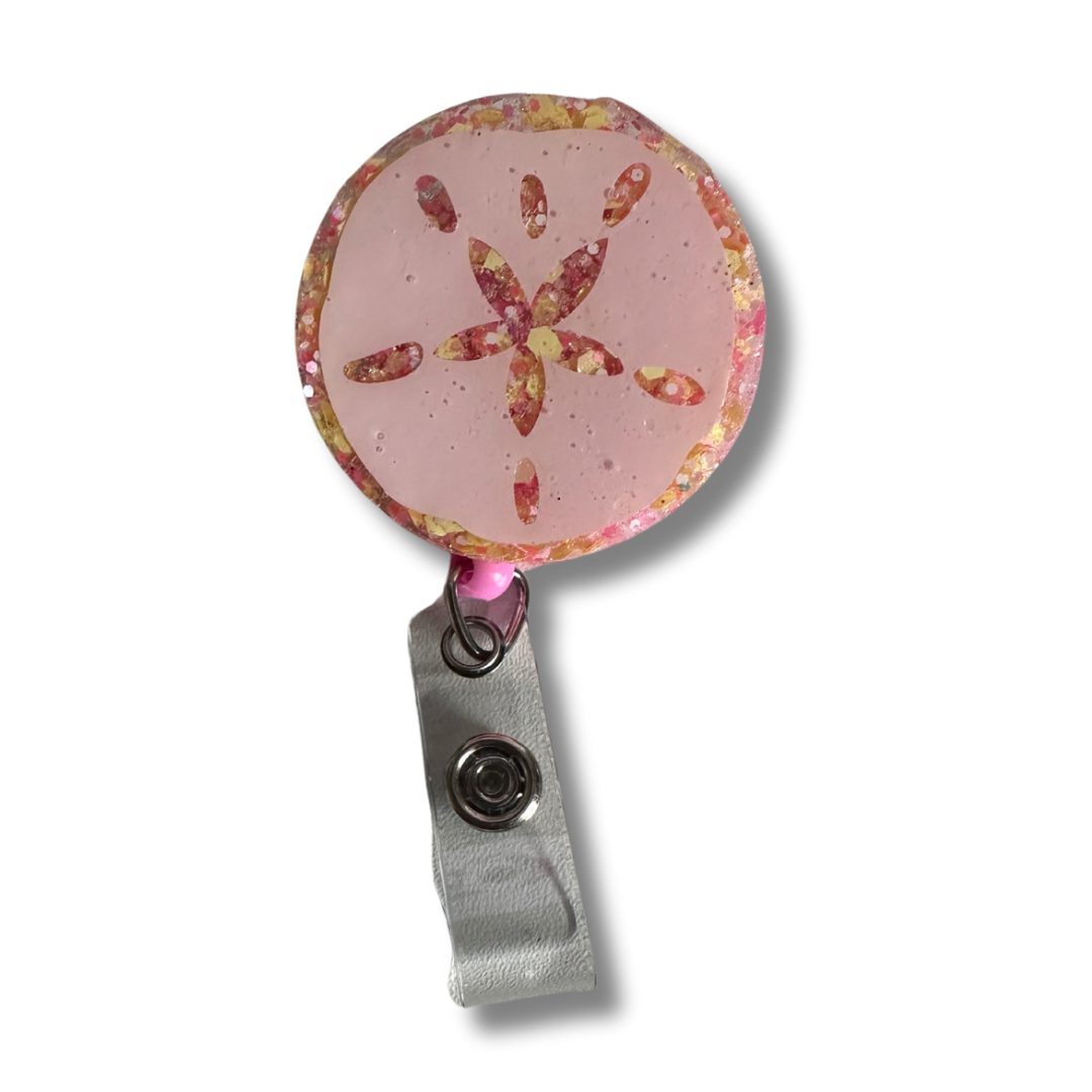 Sand Dollar badge reel perfect for teachers who love beach and ocean themes. Functional classroom accessory with retractable cord for ID badges and keys. Handcrafted design ideal for educators.