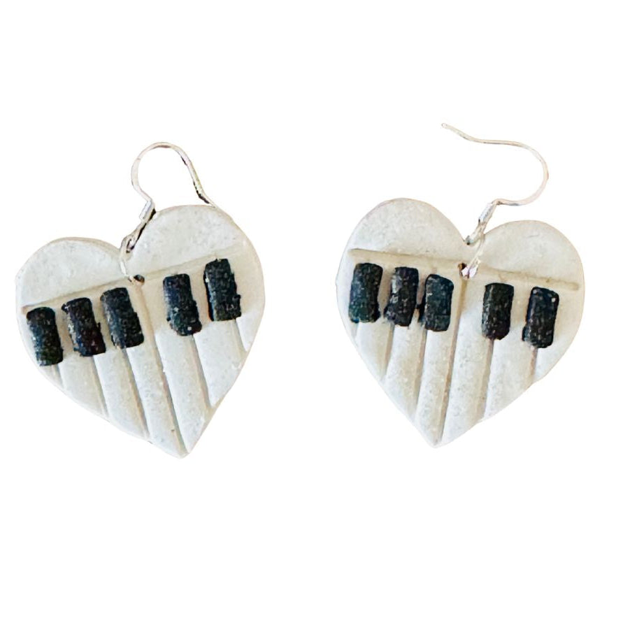 Heart-shaped earrings with piano key design on a white background
