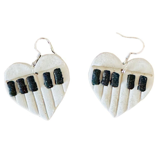 Heart-shaped earrings with piano key design on a white background