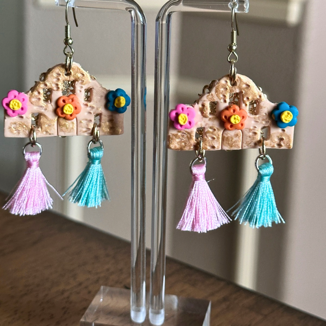 Close-up view of The Alamo Earrings showing detailed polymer clay design and colorful tassels.