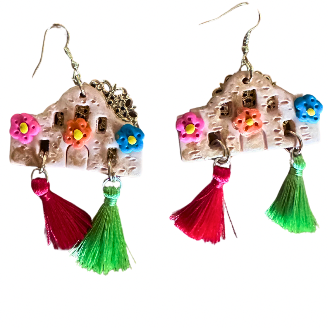 Handmade Alamo-shaped earrings in with decorative clay flowers, filigree backing, and red and green decorative tassels.