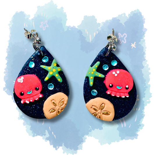 Handmade polymer clay beach earrings featuring colorful starfish, sand dollar, and octopus designs on nickel-free studs, perfect for teachers and ocean lovers.