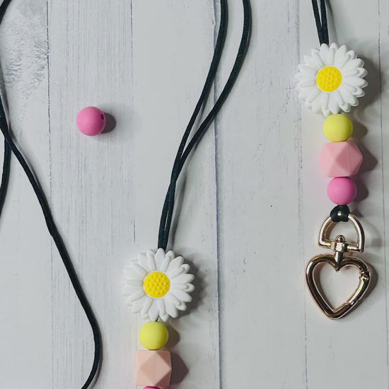The flower lanyard seen from multiple angles and zoom levels.