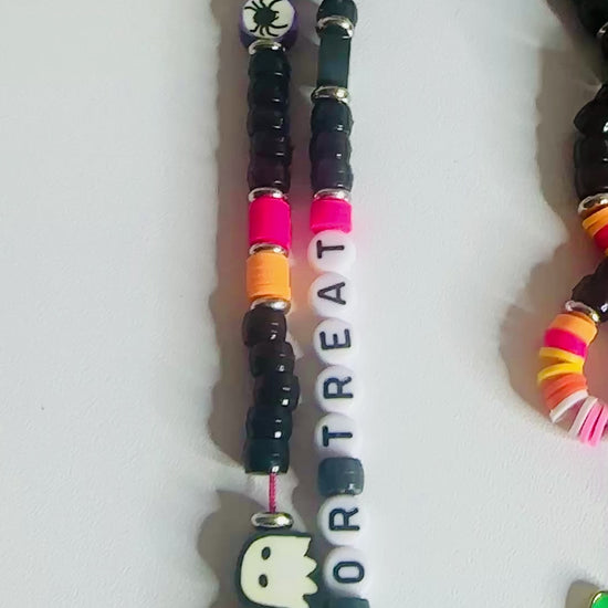 Dedicated video showcase focusing exclusively on the trick or treat Halloween lanyard, displaying the colorful bead arrangement, letter beads spelling 'Trick or Treat', Halloween themed charms, and metal clasp functionality in detail.