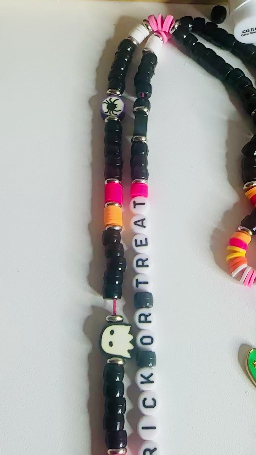 Dedicated video showcase focusing exclusively on the trick or treat Halloween lanyard, displaying the colorful bead arrangement, letter beads spelling 'Trick or Treat', Halloween themed charms, and metal clasp functionality in detail.