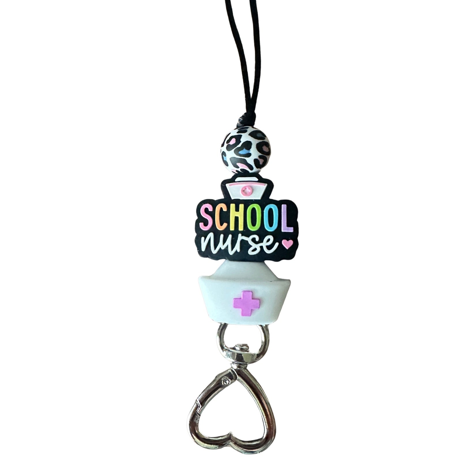Close-up of School Nurse silicone beads in rainbow letters and heart-shaped metal clasp on white background.
