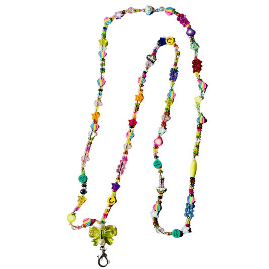 Handmade yellow bow rainbow beaded lanyard with bear heart cloud and smiley face silicone beads on white background.