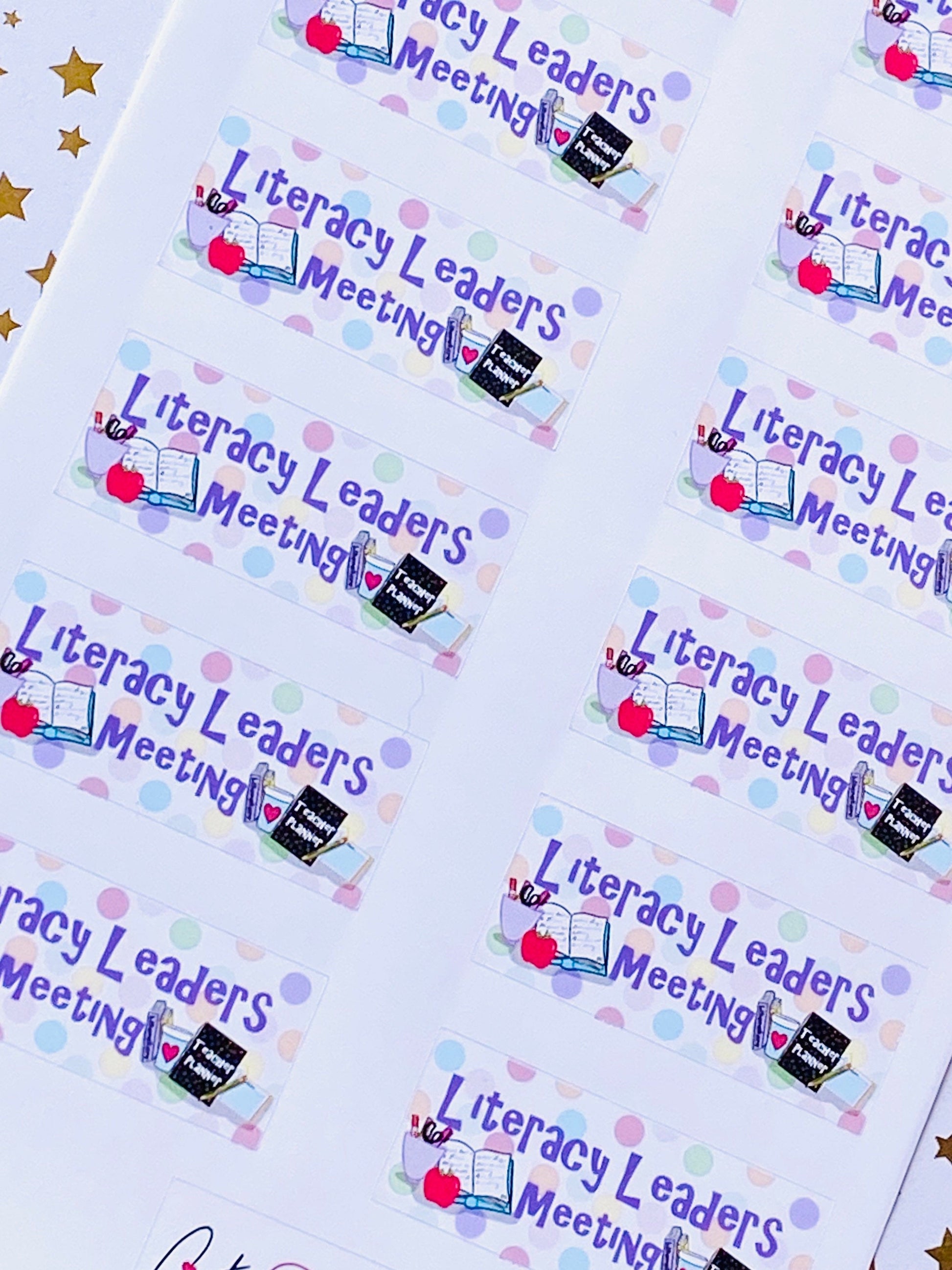 Close-up angled view of Literacy Leaders Meeting stickers showing detailed polka dots and teacher theme design