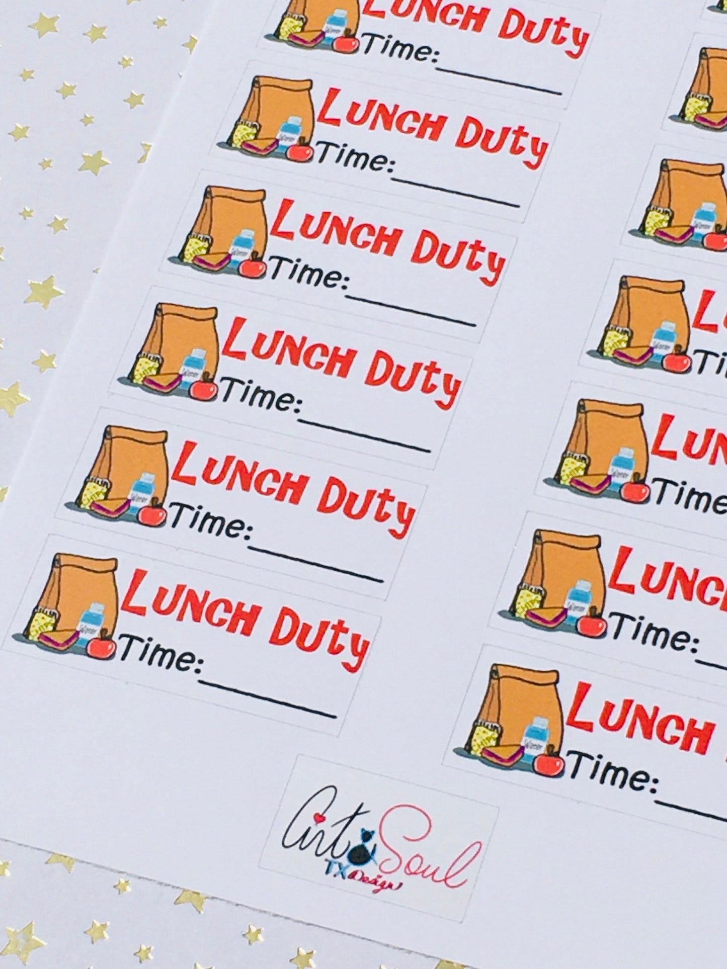 Angled close-up view of lunch duty planner stickers featuring colorful food graphics on starry background