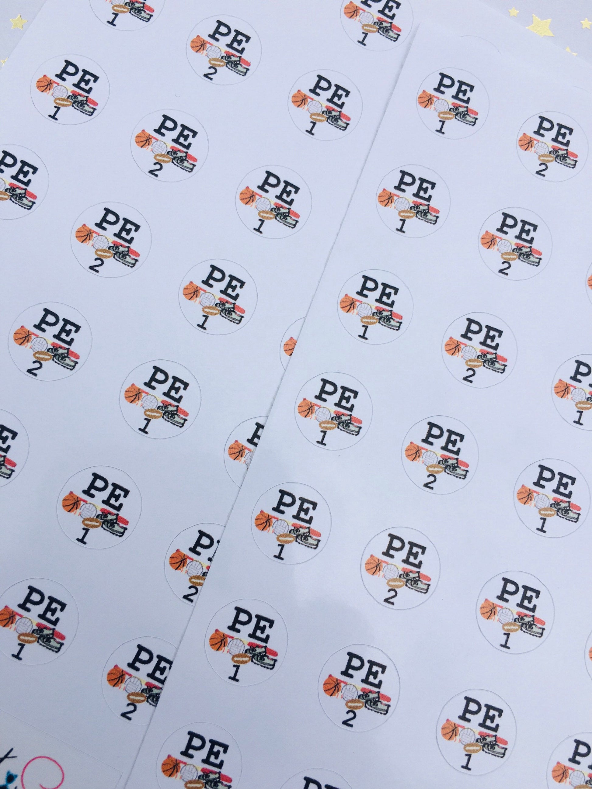 Close-up of P.E. rotation sticker sheets with baseball, basketball, and football sports designs