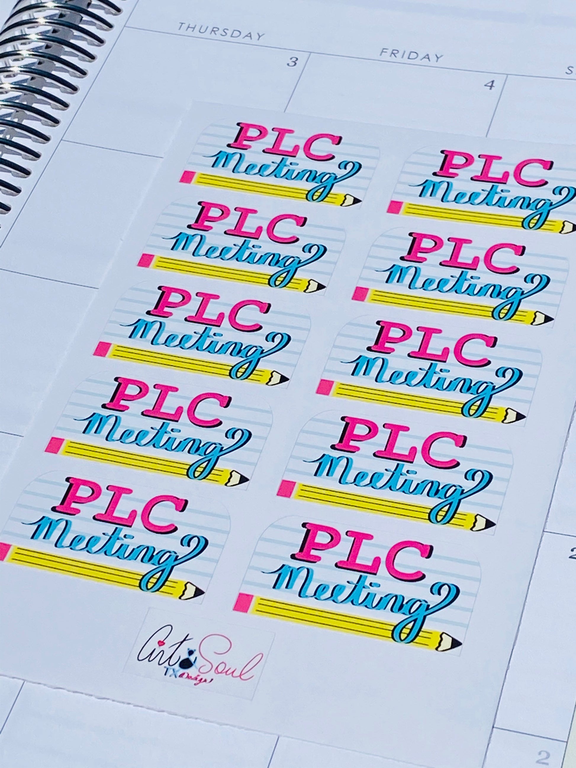 PLC Meeting sticker sheet in open teacher planner calendar page, angled view showing matte vinyl finish.