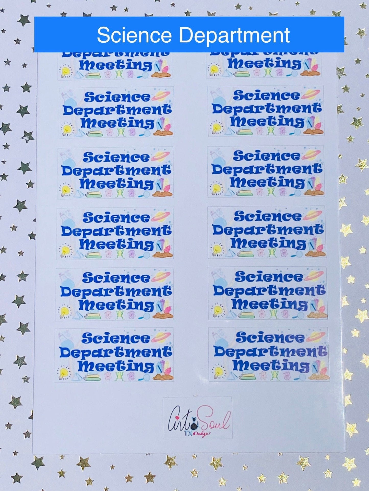 Close-up of science department meeting planner sticker on starry background showing blue text and science graphics.